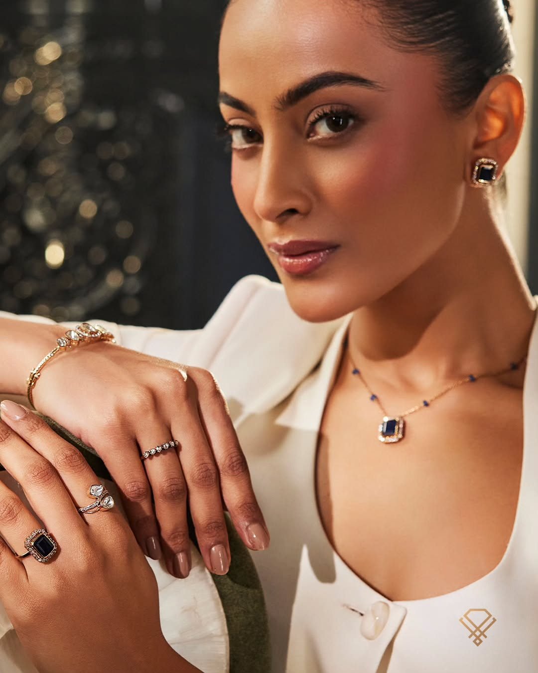 A model in ivory wearing an AGN diamond pendant and ring — the house campaign
